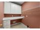 Functional laundry room with white cabinets, countertop, and a convenient utility sink at 340 Antebellum Way, Fayetteville, GA 30215