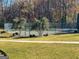 View of a fenced tennis court surrounded by lush greenery and trees in a serene outdoor setting at 340 Antebellum Way, Fayetteville, GA 30215