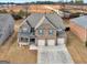 Expansive aerial view of a large brick home with well-manicured lawn and driveway at 1225 Polk Xing, Mcdonough, GA 30252