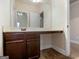 Bathroom featuring dark wood cabinets, a long countertop, and a bright mirror at 1225 Polk Xing, Mcdonough, GA 30252
