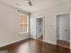 Cozy bedroom features a ceiling fan, hardwood floors, and doorway to an ensuite bath at 1225 Polk Xing, Mcdonough, GA 30252