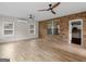 Bonus room features a brick accent wall, ceiling fans, and an entry doorway at 1225 Polk Xing, Mcdonough, GA 30252