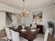 Elegant dining room with a hardwood table, chandelier, and wainscoting at 1225 Polk Xing, Mcdonough, GA 30252