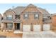 Stunning brick home featuring a three-car garage and a welcoming front entrance at 1225 Polk Xing, Mcdonough, GA 30252