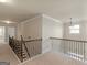 Hallway with carpet and beautiful black metal and wood banister and railing at 1225 Polk Xing, Mcdonough, GA 30252