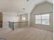 Loft area showcasing neutral carpeting, a chandelier, and a window for natural light at 1225 Polk Xing, Mcdonough, GA 30252