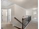 Hallway with carpet and beautiful black metal and wood banister at 1225 Polk Xing, Mcdonough, GA 30252