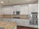 Bright kitchen showcasing stainless steel appliances, including oven and microwave at 1225 Polk Xing, Mcdonough, GA 30252