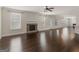 Spacious living room with hardwood floors, stone fireplace, and large windows at 1225 Polk Xing, Mcdonough, GA 30252