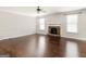 Cozy living room featuring hardwood floors and a stone fireplace at 1225 Polk Xing, Mcdonough, GA 30252