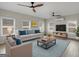 Bright living room with plush seating, ceiling fans, and natural light at 1225 Polk Xing, Mcdonough, GA 30252