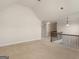 Spacious loft area with neutral tones and a decorative wrought iron railing at 1225 Polk Xing, Mcdonough, GA 30252