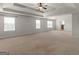 Expansive main bedroom boasts tray ceilings, plush carpet, and abundant natural light from multiple windows at 1225 Polk Xing, Mcdonough, GA 30252