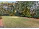 Large backyard features a well-maintained lawn, mature trees and pleasant landscaping at 248 Montrose Dr, Mcdonough, GA 30253