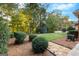 Beautiful backyard featuring a well-maintained lawn, mature trees and manicured shrubbery at 248 Montrose Dr, Mcdonough, GA 30253