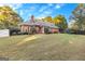 Spacious backyard features a well-maintained lawn and a timeless brick home at 248 Montrose Dr, Mcdonough, GA 30253