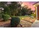 Lush backyard features manicured shrubbery, a stone pathway, and landscape lighting at 248 Montrose Dr, Mcdonough, GA 30253