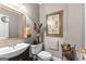 Half-bath features modern vanity, mirror, and tasteful decor at 248 Montrose Dr, Mcdonough, GA 30253