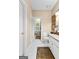 Bathroom with white vanity, granite countertop, and patterned rugs at 248 Montrose Dr, Mcdonough, GA 30253