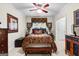 Cozy bedroom with patterned bedding, a ceiling fan, and natural light from the window at 248 Montrose Dr, Mcdonough, GA 30253