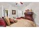 Bedroom with a carved wooden bed, soft bedding, and an ensuite bathroom access at 248 Montrose Dr, Mcdonough, GA 30253