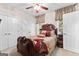 Bedroom with a carved, dark wood bed frame, matching furniture, and bright natural light at 248 Montrose Dr, Mcdonough, GA 30253