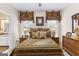 Cozy bedroom featuring wicker nightstands, matching lamps, and ensuite bathroom access at 248 Montrose Dr, Mcdonough, GA 30253