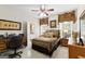 Cozy bedroom with a ceiling fan, desk area, and an ensuite bathroom at 248 Montrose Dr, Mcdonough, GA 30253