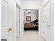 A view of a bedroom through an open doorway showing patterned bedspread and a ceiling fan at 248 Montrose Dr, Mcdonough, GA 30253