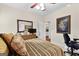 Bedroom featuring coordinated bedding, a ceiling fan, and a television on a wicker dresser at 248 Montrose Dr, Mcdonough, GA 30253