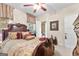 Bedroom featuring dark carved-wood bed, side table, and bright windows at 248 Montrose Dr, Mcdonough, GA 30253