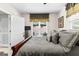 Comfortable bedroom featuring gray comforter and backyard view from the window at 248 Montrose Dr, Mcdonough, GA 30253