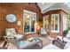 Inviting covered patio featuring comfortable wicker chairs and a glass-top table, perfect for outdoor entertaining at 248 Montrose Dr, Mcdonough, GA 30253