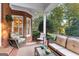 Charming covered patio featuring plush seating, wicker furniture, and a tranquil view of the landscaped backyard at 248 Montrose Dr, Mcdonough, GA 30253