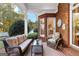 Relaxing covered patio with plush seating and lush landscaping, creating a private outdoor retreat at 248 Montrose Dr, Mcdonough, GA 30253