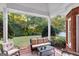 Relaxing covered patio with cushioned seating and views of the lush backyard landscaping at 248 Montrose Dr, Mcdonough, GA 30253