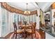 Elegant dining room featuring a bay window, chandelier, and ornate furnishings at 248 Montrose Dr, Mcdonough, GA 30253
