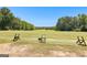 Open driving range with tee stations framed by natural tree borders at 248 Montrose Dr, Mcdonough, GA 30253