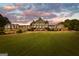 Grand exterior view of a luxurious property with manicured lawns and elegant architectural details at 248 Montrose Dr, Mcdonough, GA 30253