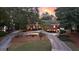 Lovely brick home with a circular driveway, mature trees and professional landscaping at 248 Montrose Dr, Mcdonough, GA 30253