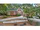 Well-maintained brick home featuring manicured landscaping, mature trees, and a stone wall at 248 Montrose Dr, Mcdonough, GA 30253