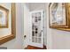 Hallway with wooden floors showcasing a glass paneled door with a view into another room at 248 Montrose Dr, Mcdonough, GA 30253