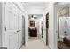 Hallway showing office and bathroom, connected by beige carpeting and white-framed doors at 248 Montrose Dr, Mcdonough, GA 30253