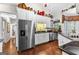 Bright kitchen with stainless steel appliances, white cabinets, and wood floors at 248 Montrose Dr, Mcdonough, GA 30253