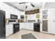 Charming kitchen with white cabinetry, black appliances, and a built-in wine rack for a touch of elegance at 248 Montrose Dr, Mcdonough, GA 30253
