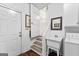 Laundry room with utility sink, washer, dryer, and storage cabinets at 248 Montrose Dr, Mcdonough, GA 30253