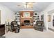 Cozy living room featuring a brick fireplace, built-in shelving, and comfortable seating for relaxing evenings at 248 Montrose Dr, Mcdonough, GA 30253