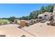 Expansive patio with comfortable seating, stone fire pit, and stunning views of the adjacent golf course and trees at 248 Montrose Dr, Mcdonough, GA 30253
