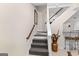 Carpeted stairway with wooden handrail leading to basement recreation area and bar at 248 Montrose Dr, Mcdonough, GA 30253