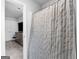 View of the gray-and-white striped shower curtain from the doorway at 445 Sawmill Trce, Hampton, GA 30228